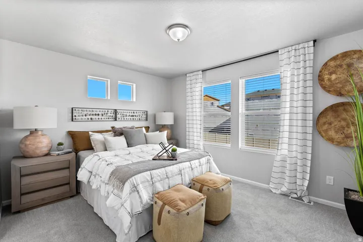 Recessed ceiling light fixture, twin windows with blinds, two high horizontal windows, gray wall-to-wall carpeting, and light gray painted walls
