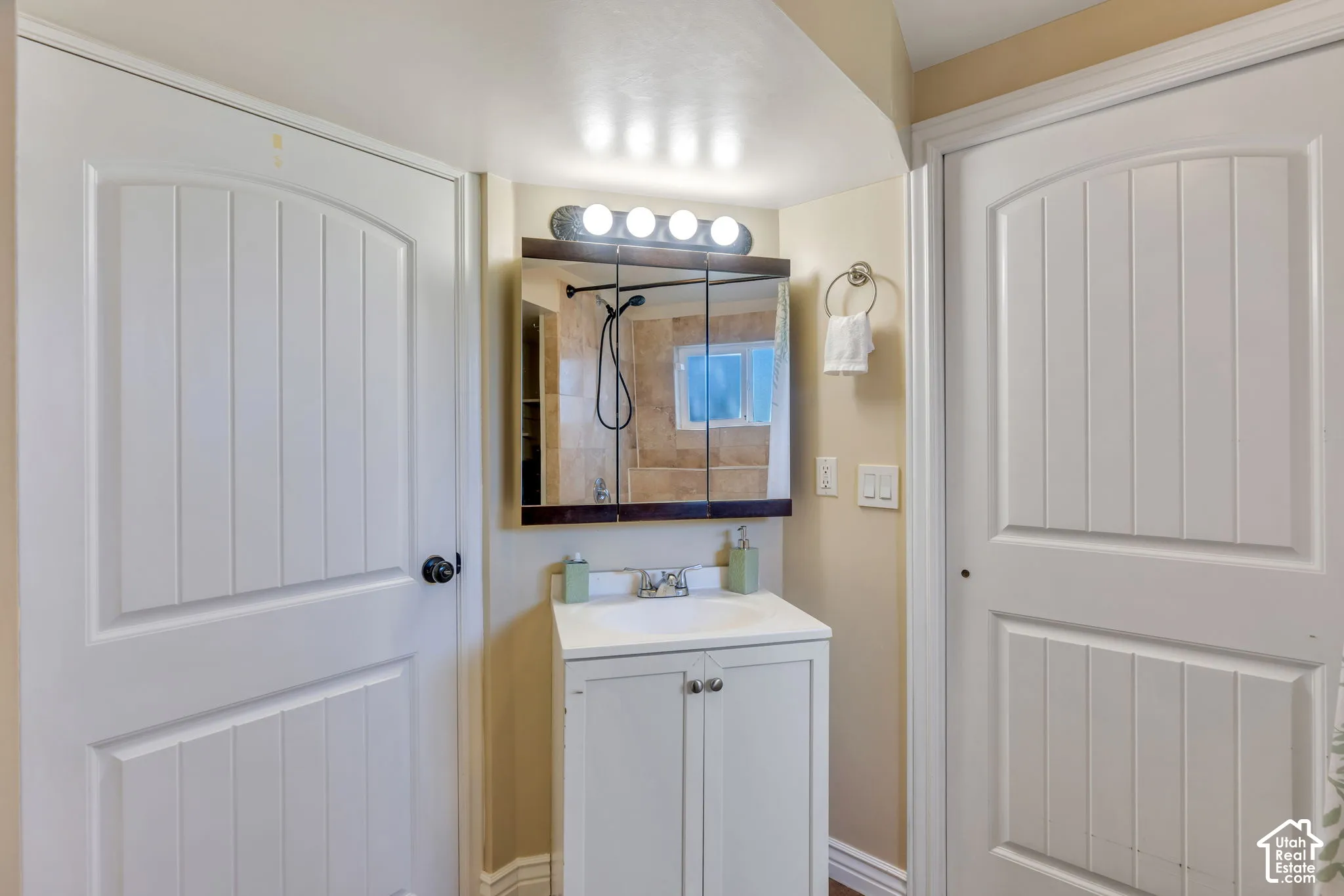 Updated downstairs bathroom features a stylish vanity and sink area with a clean, fresh look.