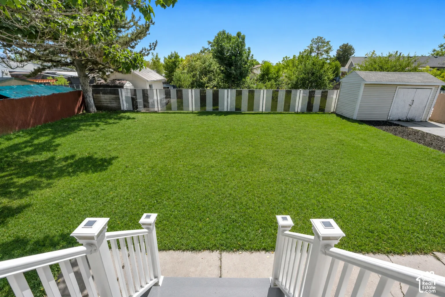 Enjoy the view from the deck overlooking the expansive, fully fenced backyard with beautiful mature trees and plenty of room to enjoy.