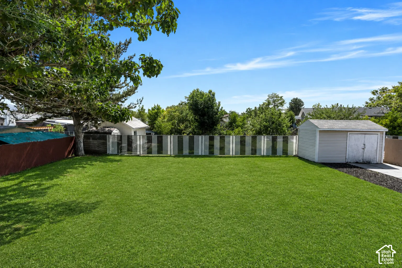 Beautiful, fully fenced backyard surrounded by mature trees for wonderful shade and privacy.