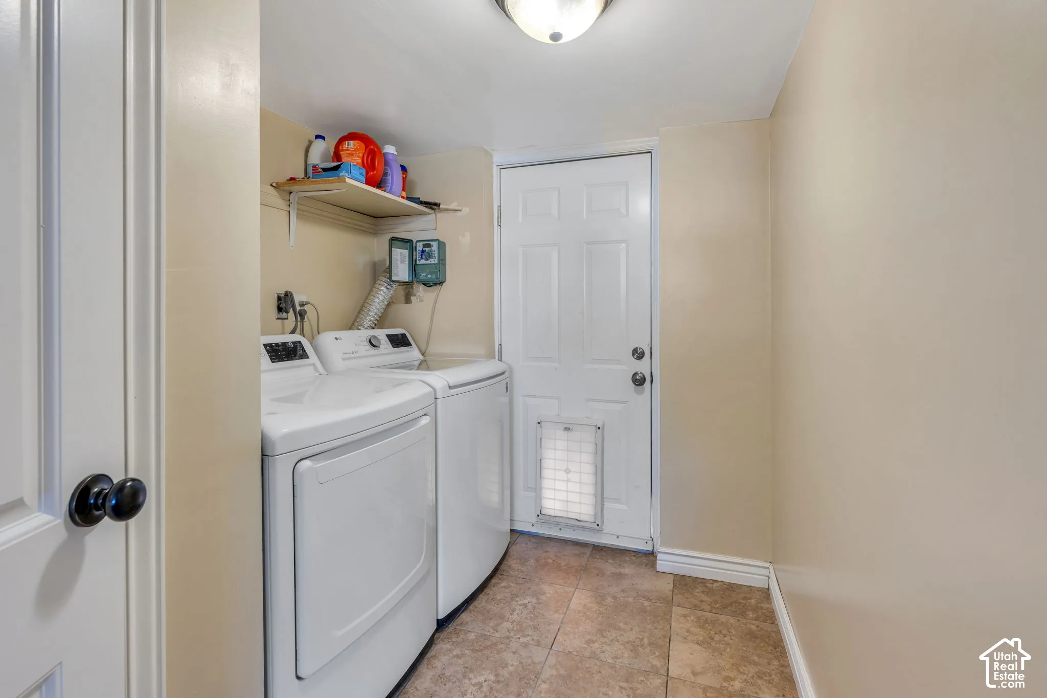 Large laundry room with plenty of space for laundry, storage and household essentials, and direct access to backyard through separate entrance.
