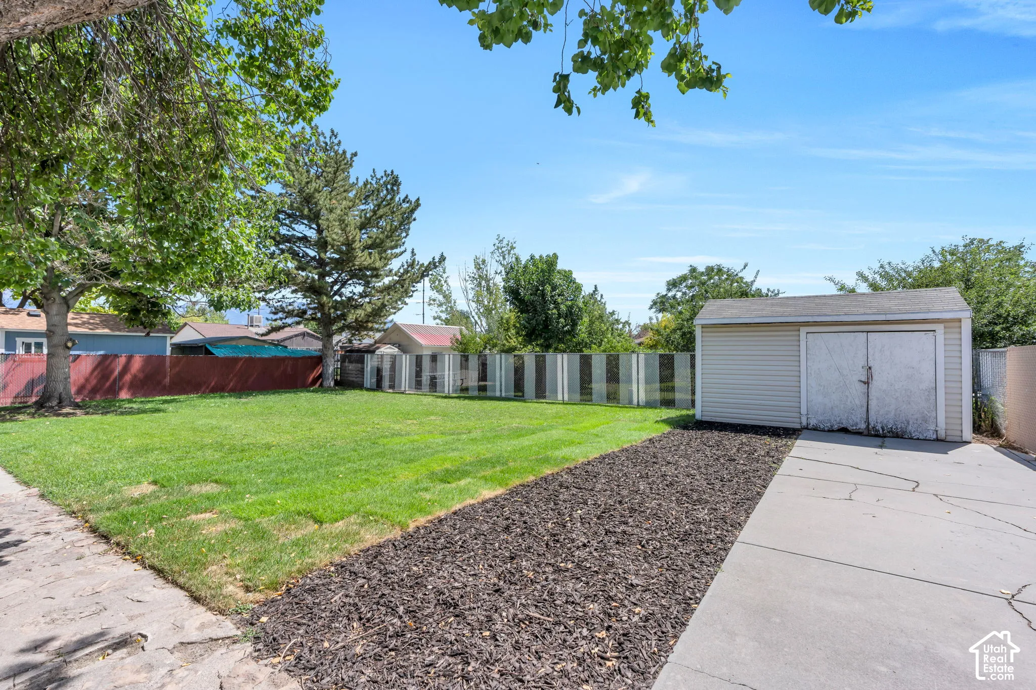 Additional backyard patio space provides even more room for outdoor dining, entertaining, or simply relaxing and enjoying the private setting.