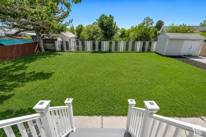 Enjoy the view from the deck overlooking the expansive, fully fenced backyard with beautiful mature trees and plenty of room to enjoy.