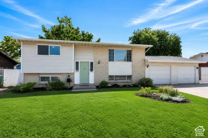 Welcoming split-level home with a 2-car garage, generous driveway and gated RV parking.