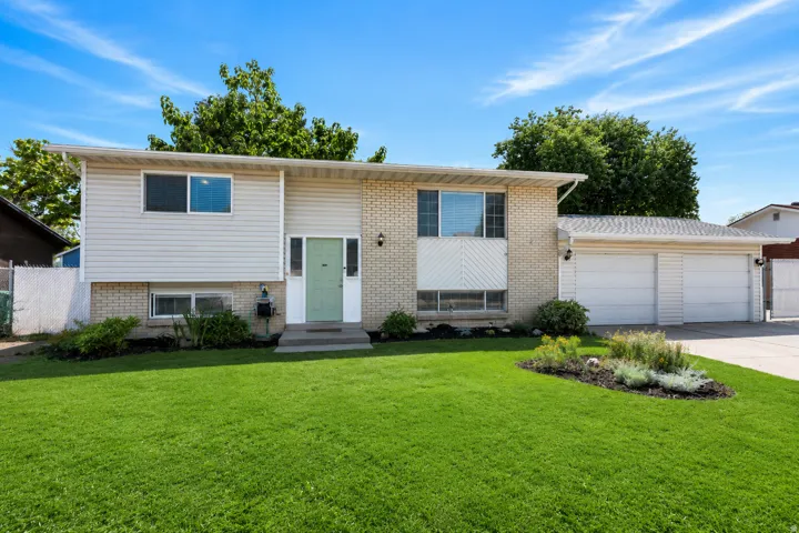 Welcoming split-level home with a 2-car garage, generous driveway and gated RV parking.