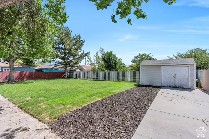 Additional backyard patio space provides even more room for outdoor dining, entertaining, or simply relaxing and enjoying the private setting.