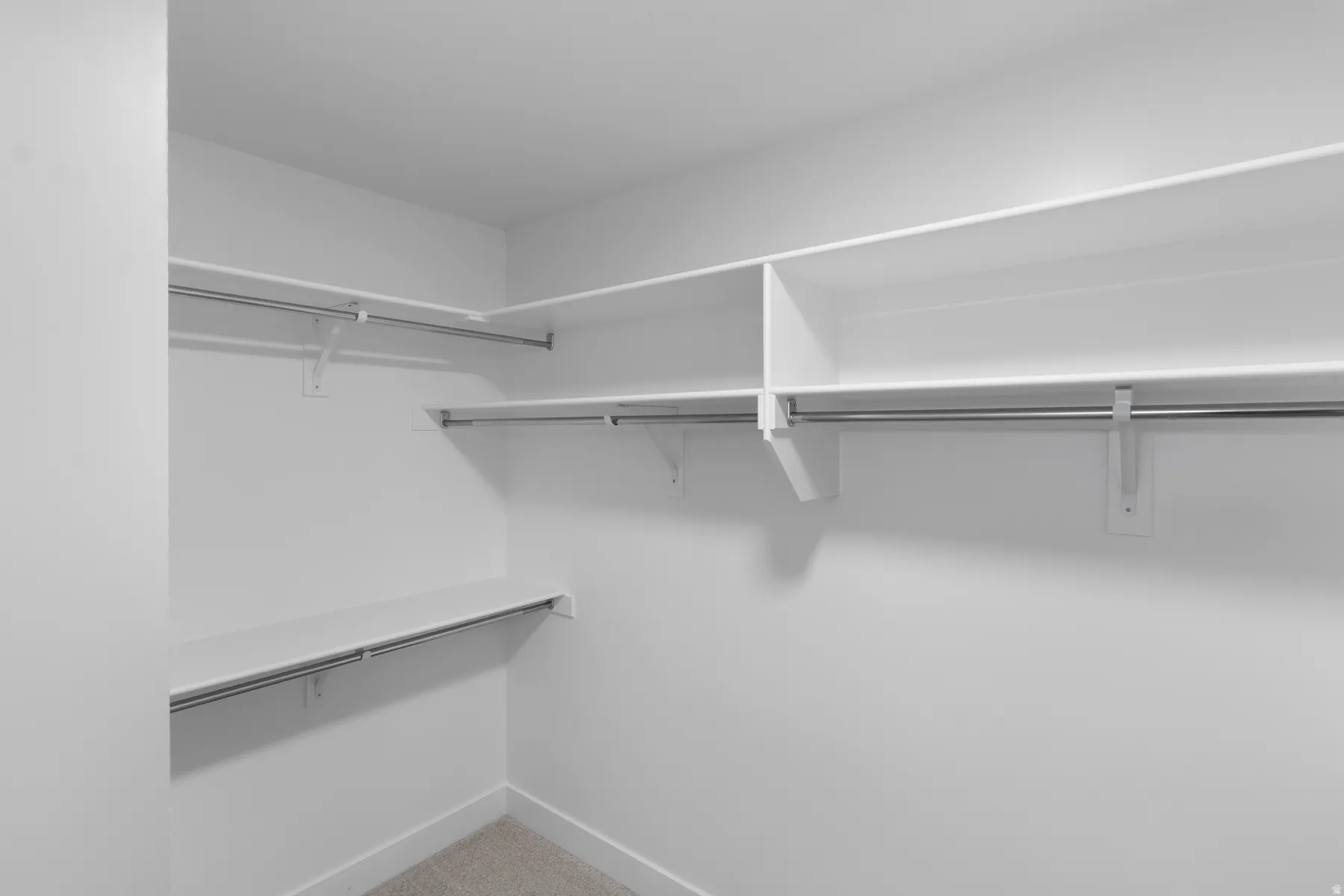 Built-in shelving with hanging rods and carpet flooring