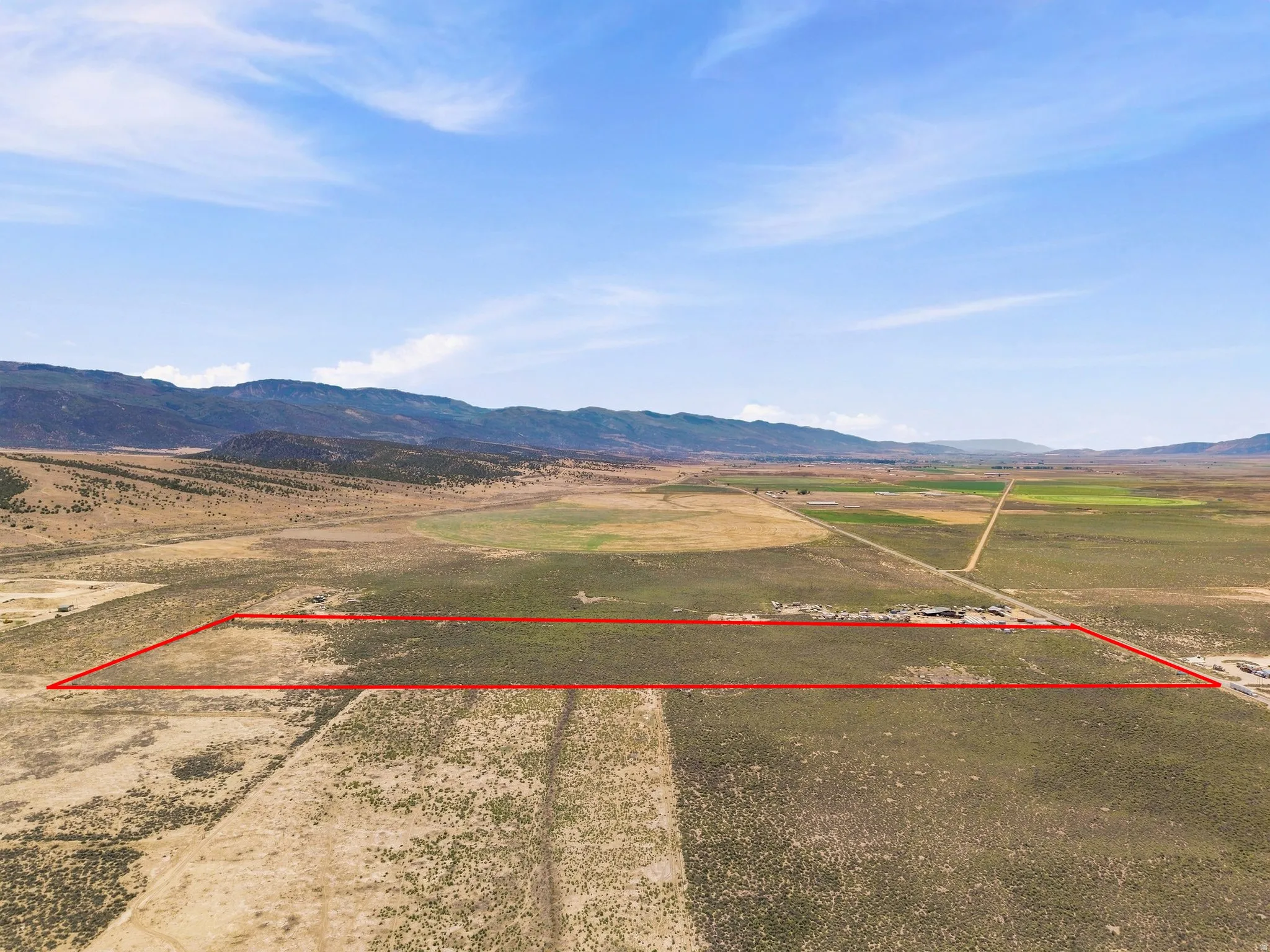 Expansive land parcel with surrounding mountain range