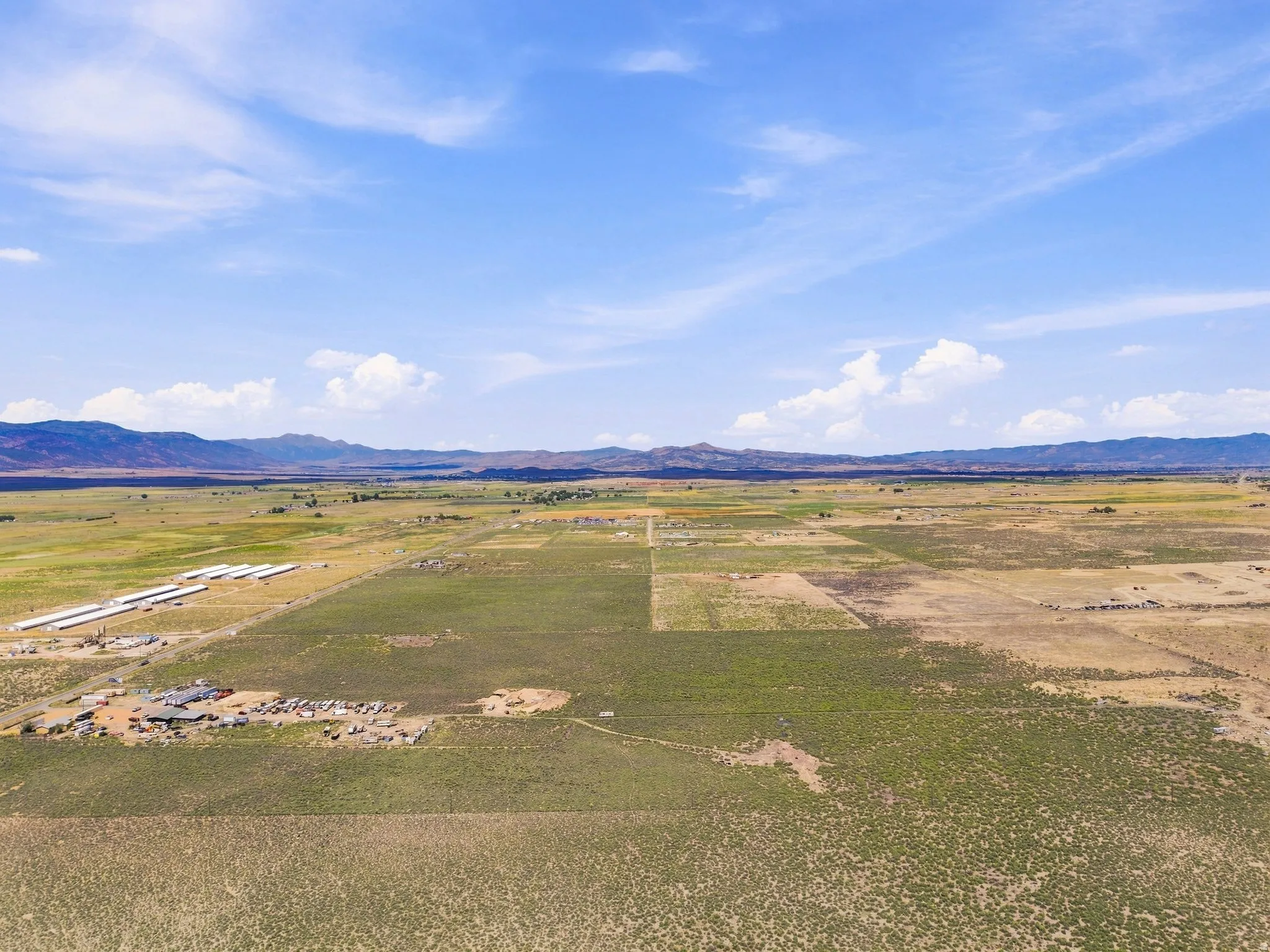 Expansive open land with distant mountain ranges