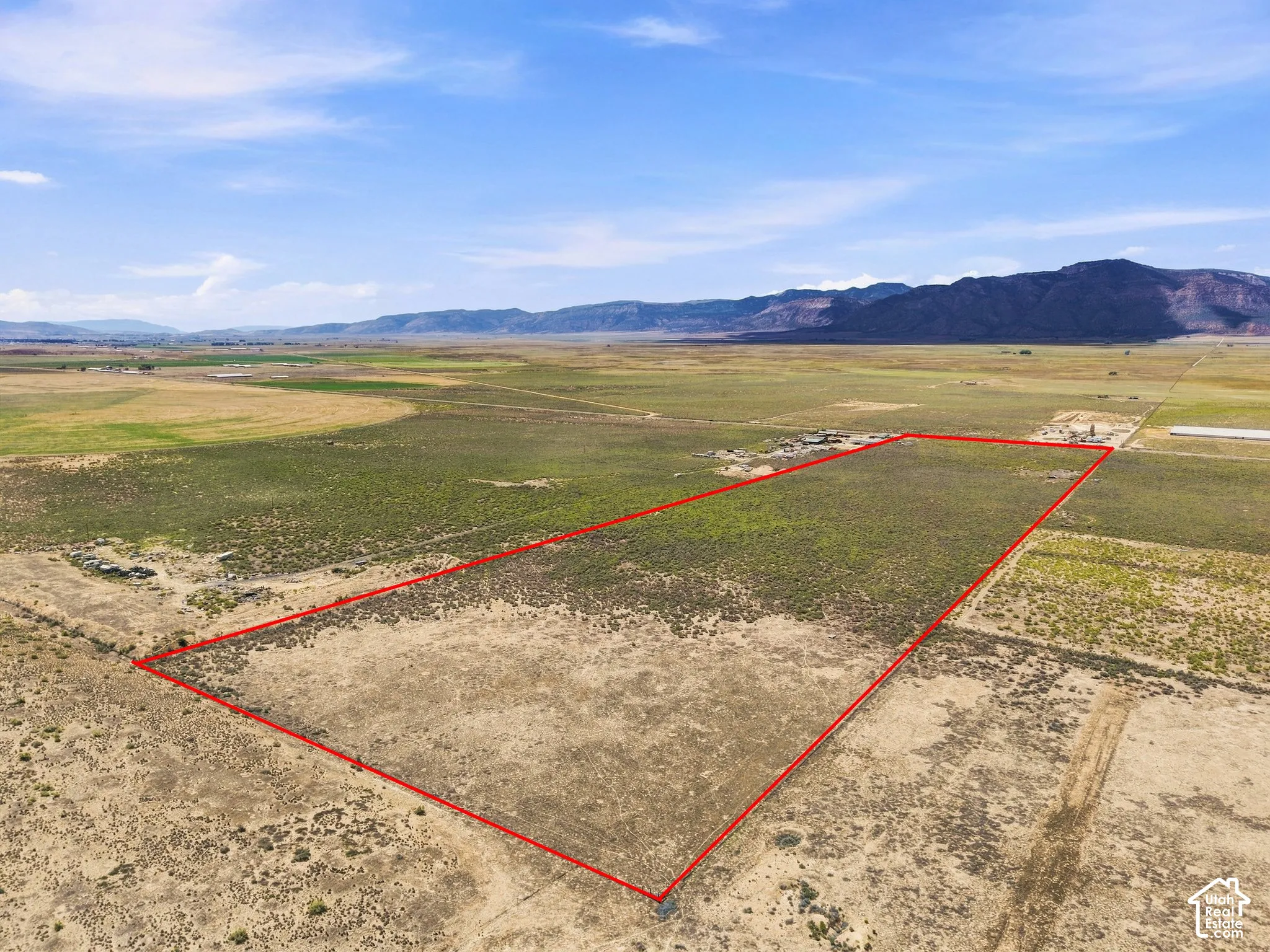 Expansive undeveloped land with a distant mountainous backdrop