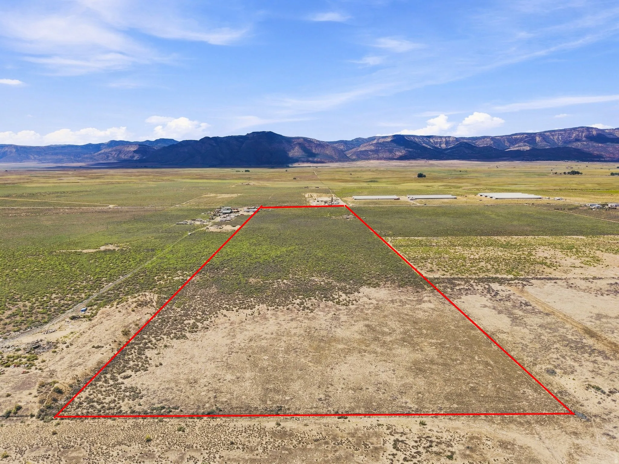 Expansive open land with a distinct red boundary