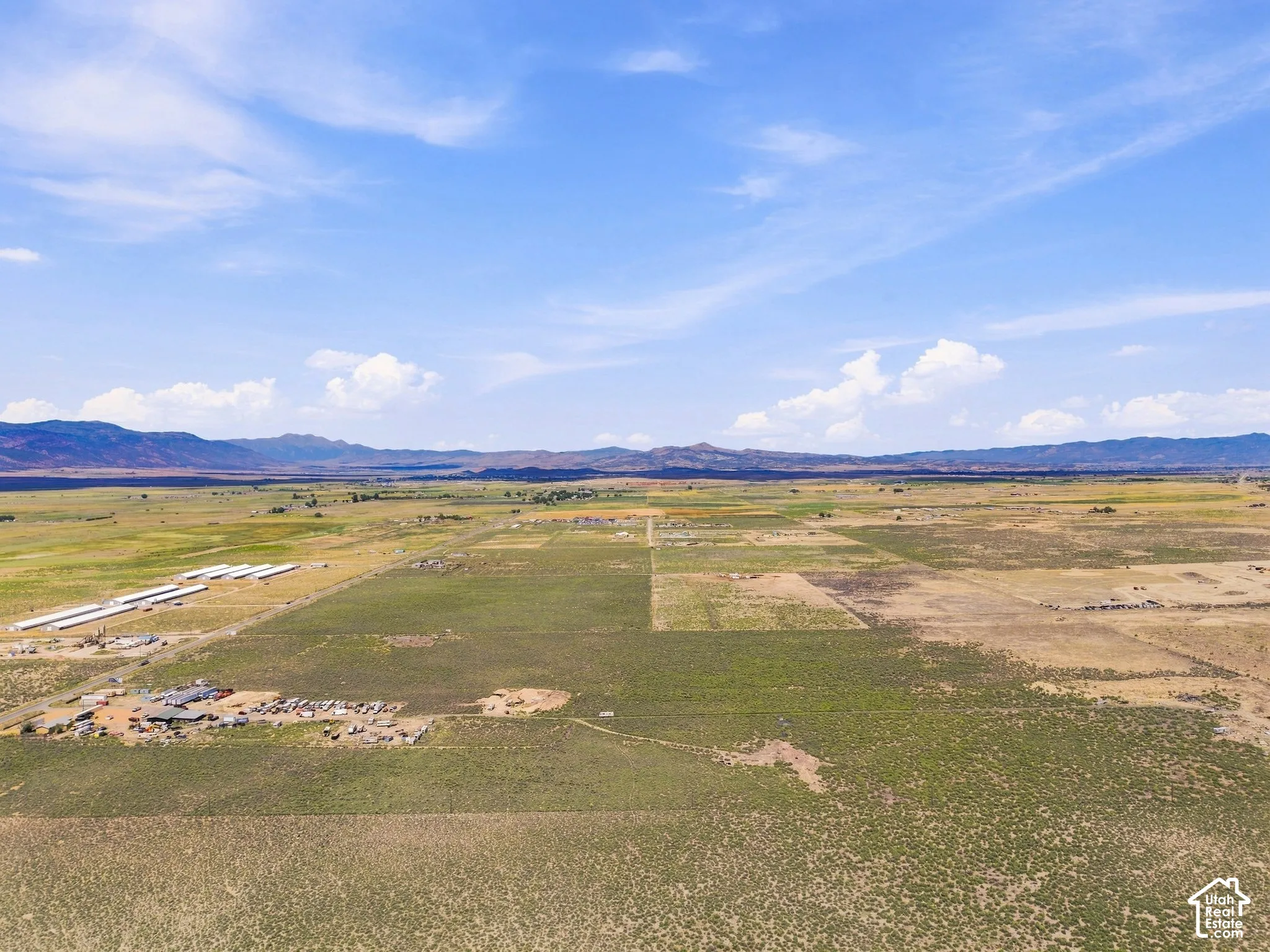 Expansive open land with distant mountain ranges