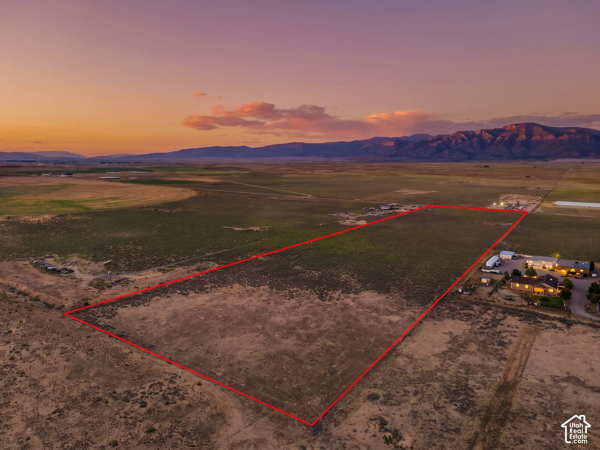 Expansive parcel with mountain backdrop, clear boundary lines, and surrounding natural landscape