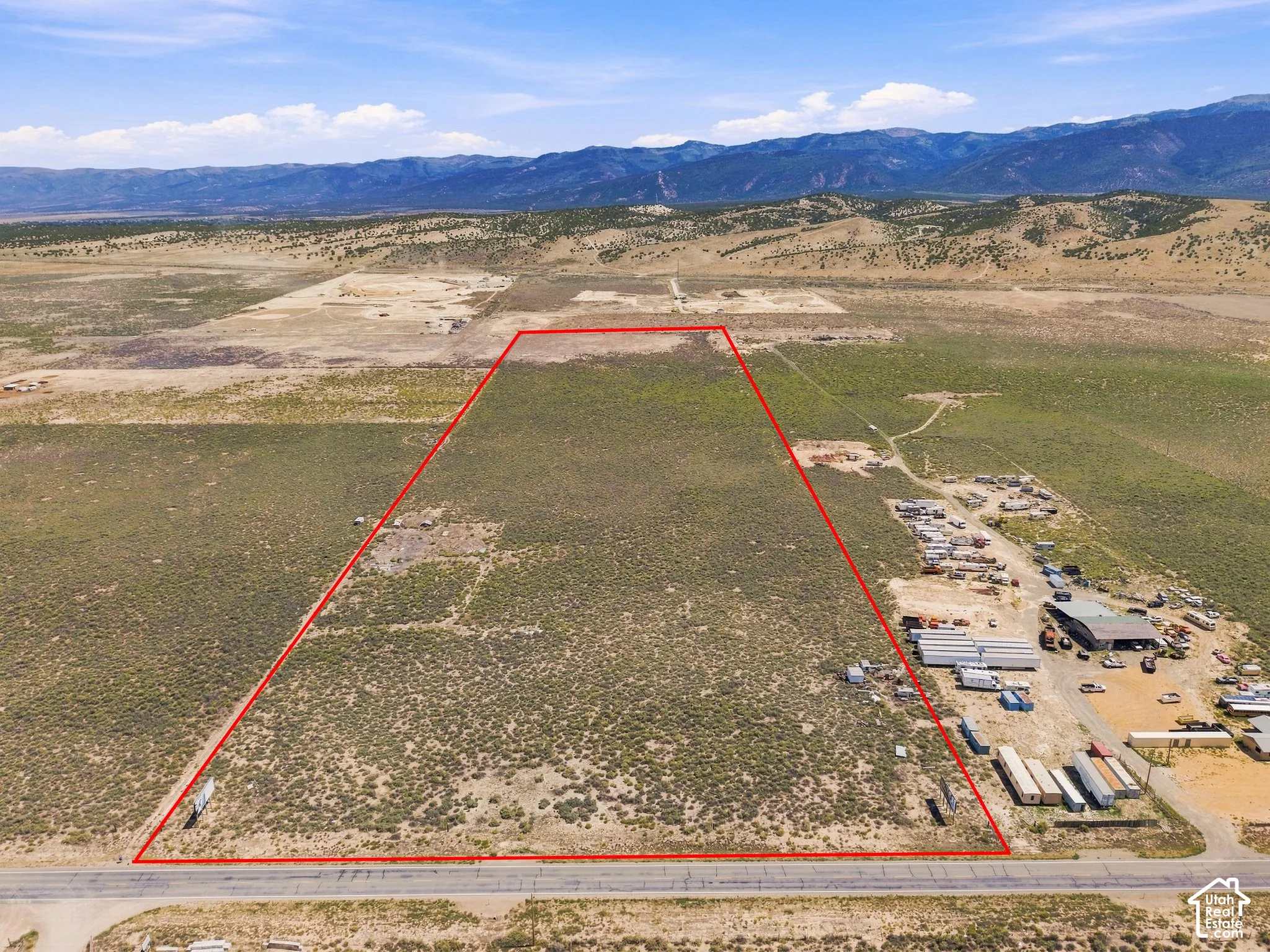 Expansive undeveloped lot with natural vegetation and mountainous surroundings