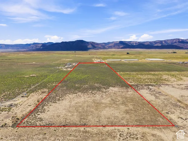 Expansive open land with a distinct red boundary