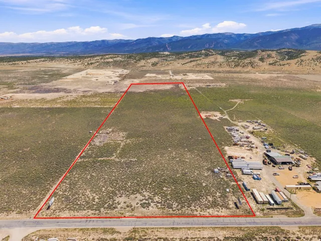 Expansive undeveloped lot with natural vegetation and mountainous surroundings