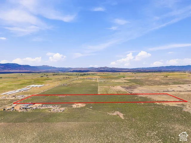 Expansive land parcel featuring open fields and distant mountain ranges