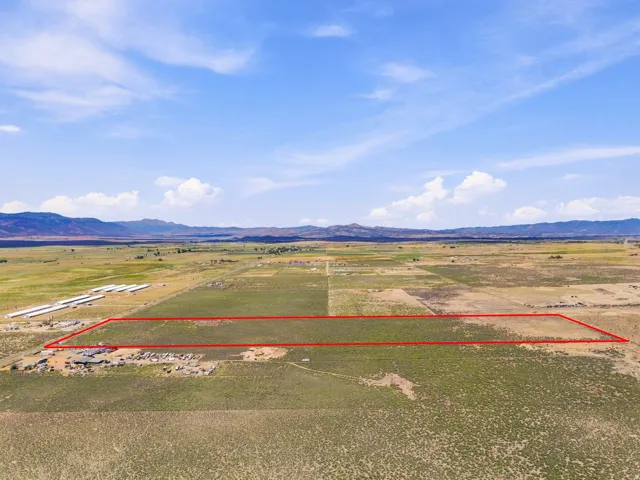 Expansive land parcel featuring open fields and distant mountain ranges