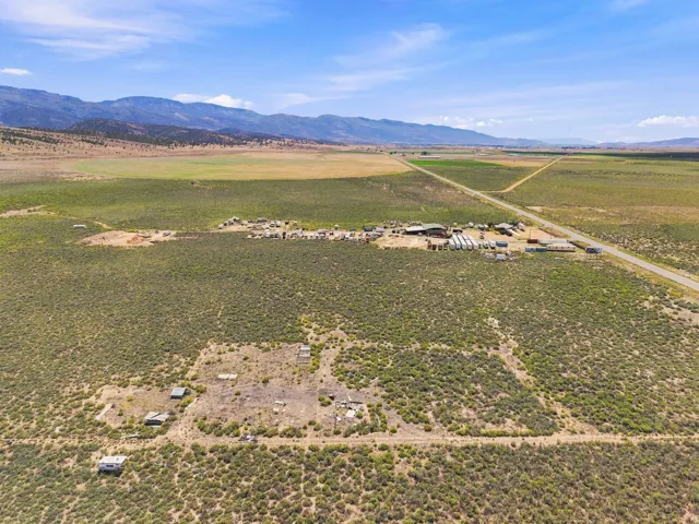 Expansive rural landscape featuring a central building cluster and a road network