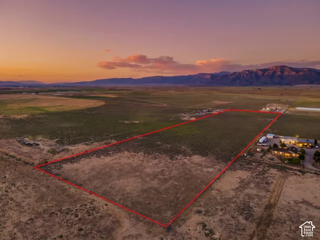 Expansive undeveloped land with a flat topography, bordered by a defined property line. Twilight is virtually added.