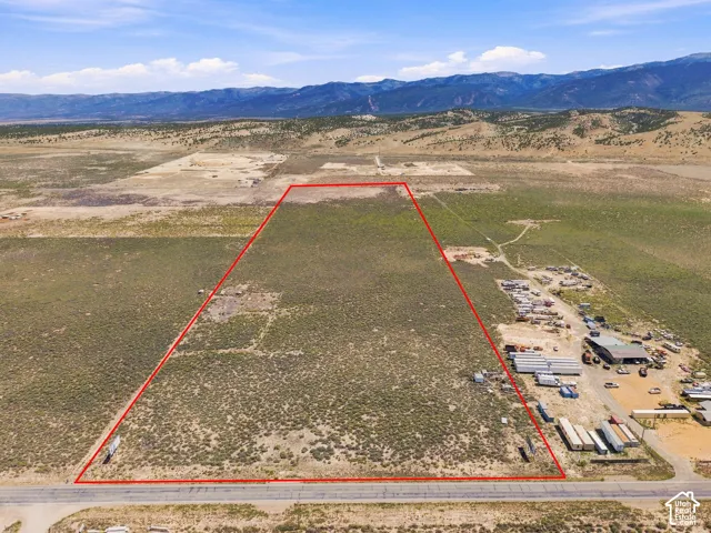 Expansive undeveloped lot with natural vegetation and mountainous surroundings