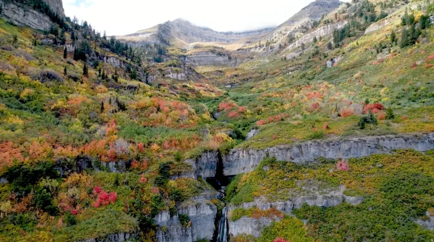 Mountainous terrain with natural rock formations, featuring diverse foliage