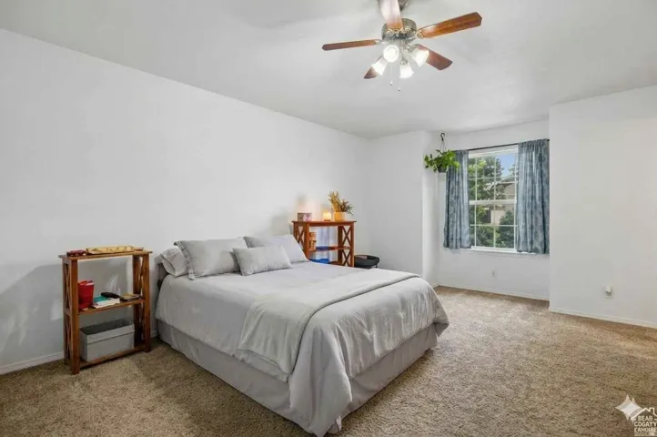 Recessed window, ceiling fan, and carpet flooring