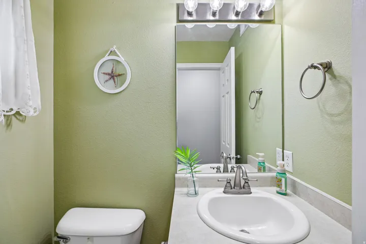 Vanity featuring a built-in sink, gray countertop, and brushed nickel faucet