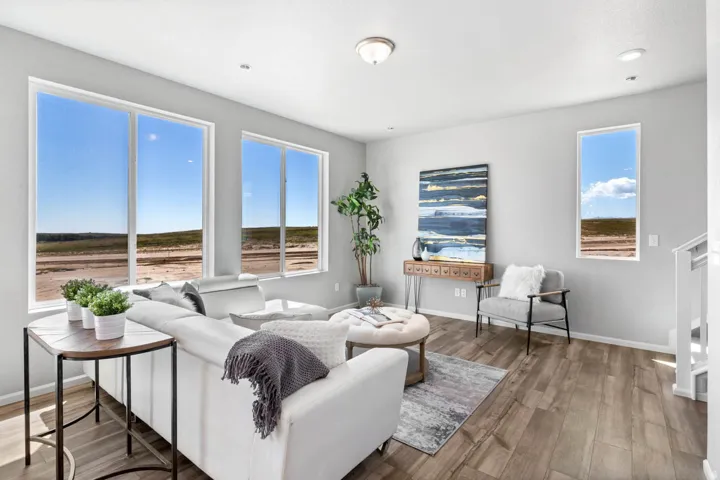 Wood-finish flooring, recessed lighting, and multiple windows