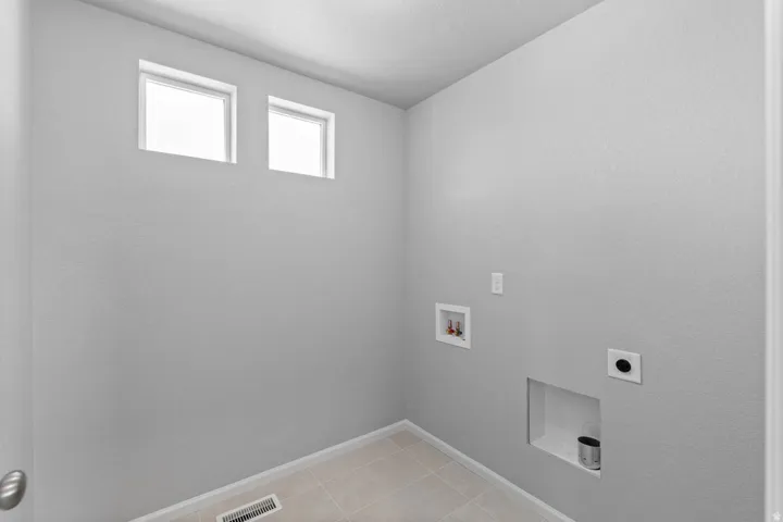 Recessed wall niche, square windows, and light-toned tile flooring