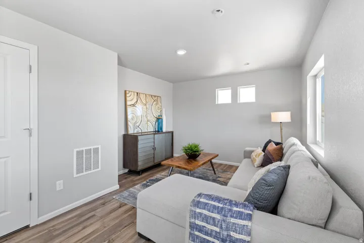 Wood-finish flooring, recessed lighting, white trim, and multiple windows