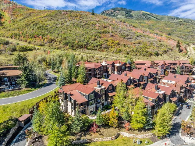 Community of properties with pitched roofs, balconies, and dormer windows