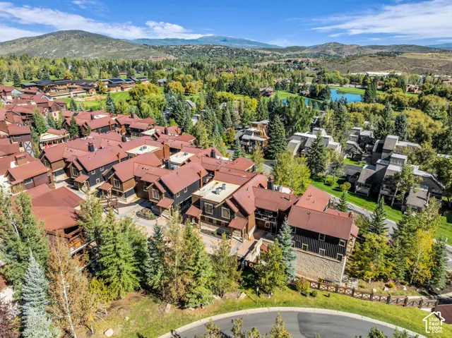 Residential complex with multi-level structures, dark siding, and red roofs
