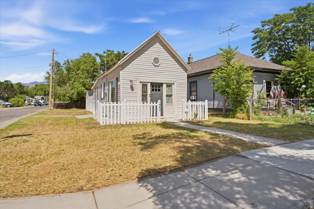 Very inviting front with a picket fence entry and gable roofline.
