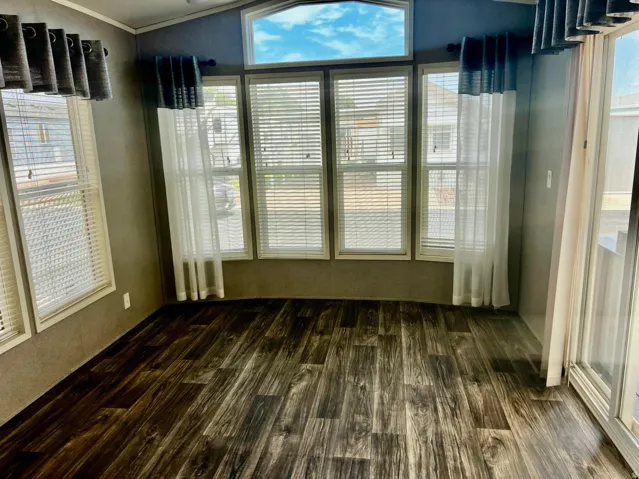 Wood-finish flooring throughout, multiple windows, and a large sliding glass door