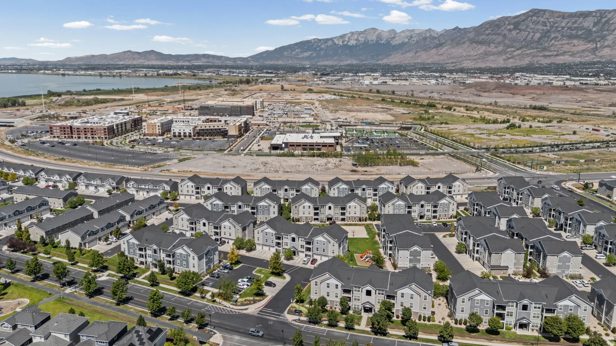 Expansive residential development featuring multi-story buildings, paved roadways, and integrated parking areas