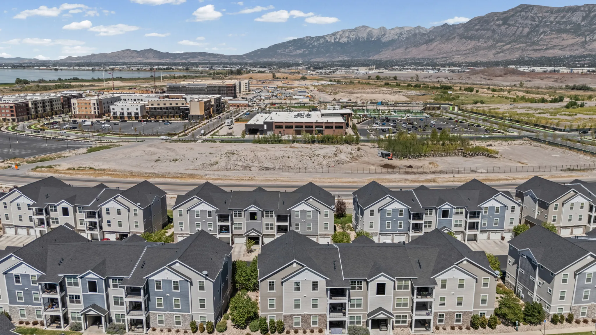 Multi-story residential buildings featuring varied siding colors and dark shingle roofs
