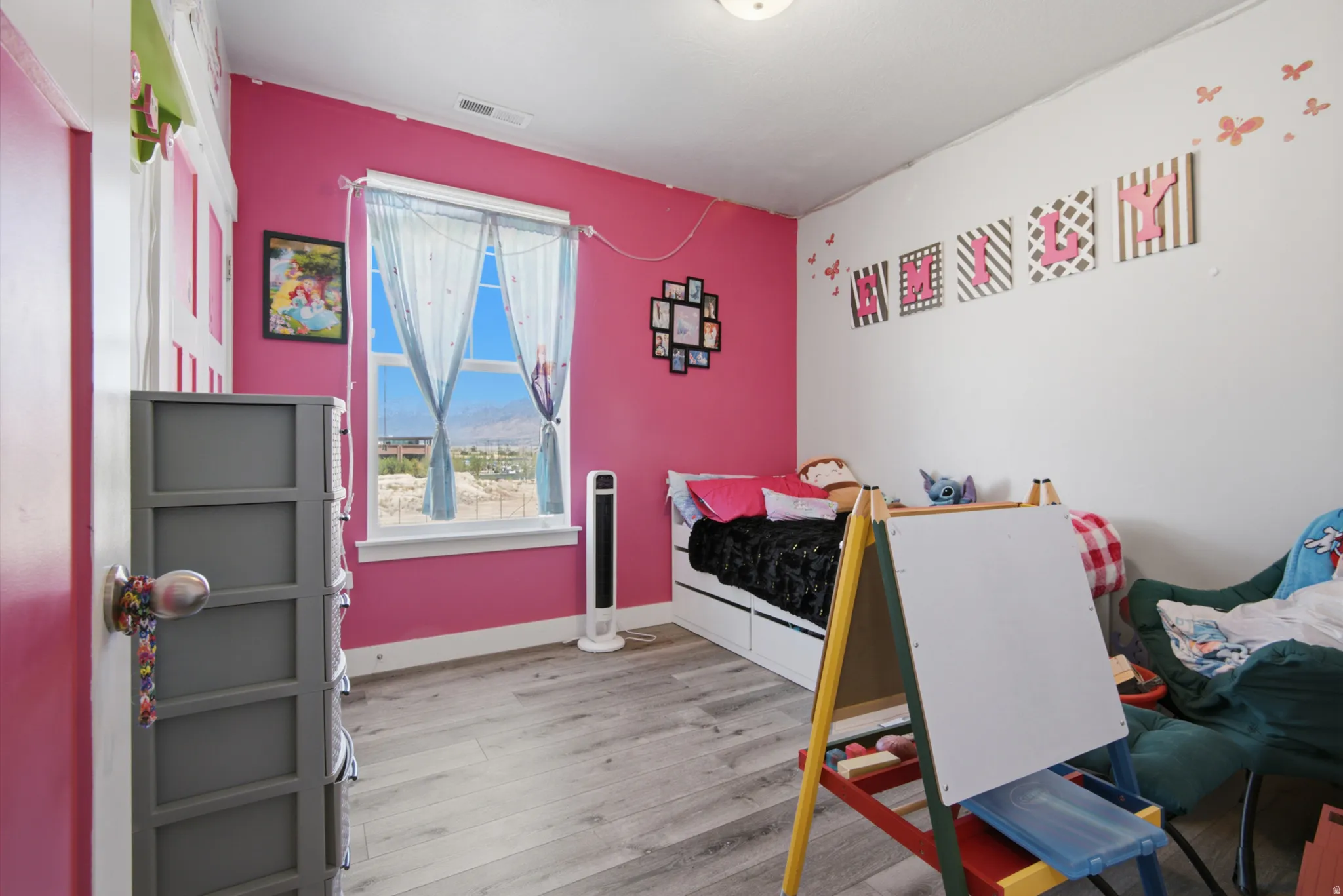 Wood-finish flooring, single window, and a built-in storage bed