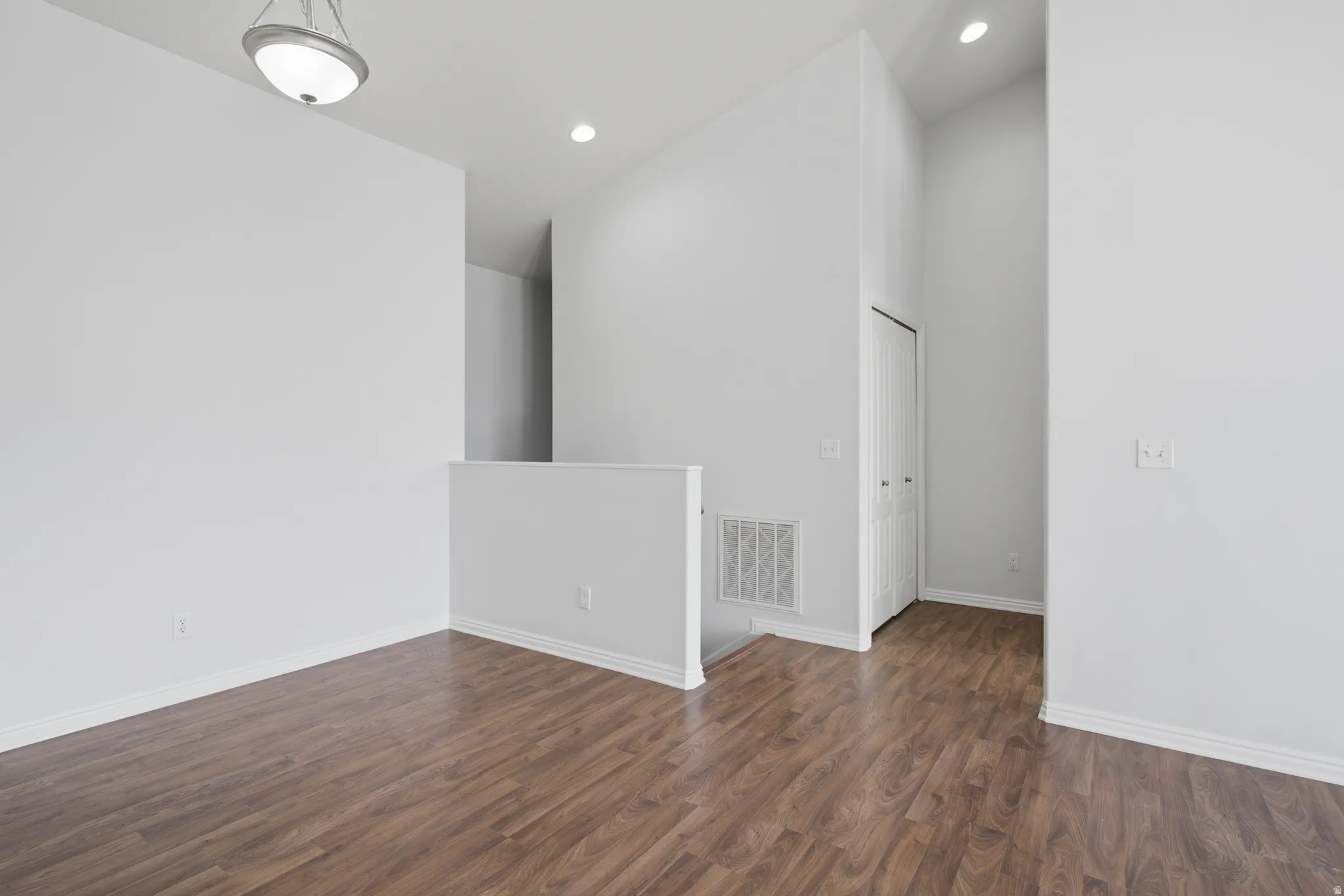 Wood-finish flooring, vaulted ceiling, and recessed lighting