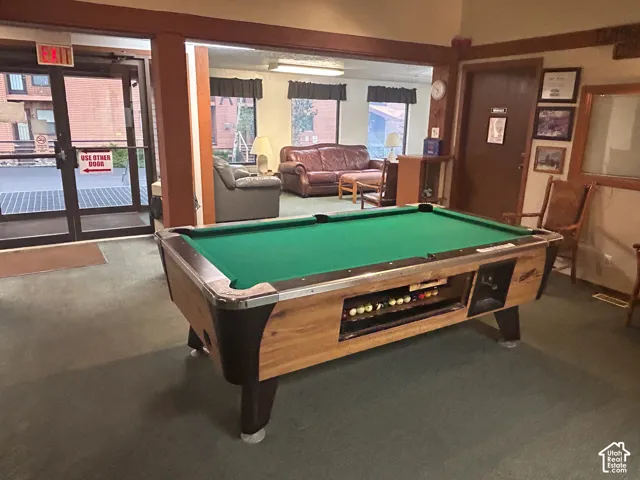 Recreational space featuring a billiard table with wood-finish siding, green felt, and integrated ball return