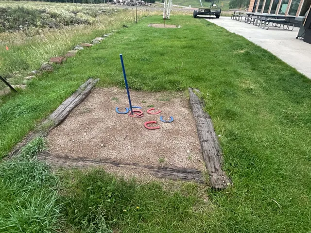 Horseshoe pit featuring a gravel base, timber borders, and a central stake