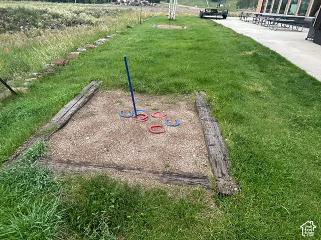 Horseshoe pit featuring a gravel base, timber borders, and a central stake