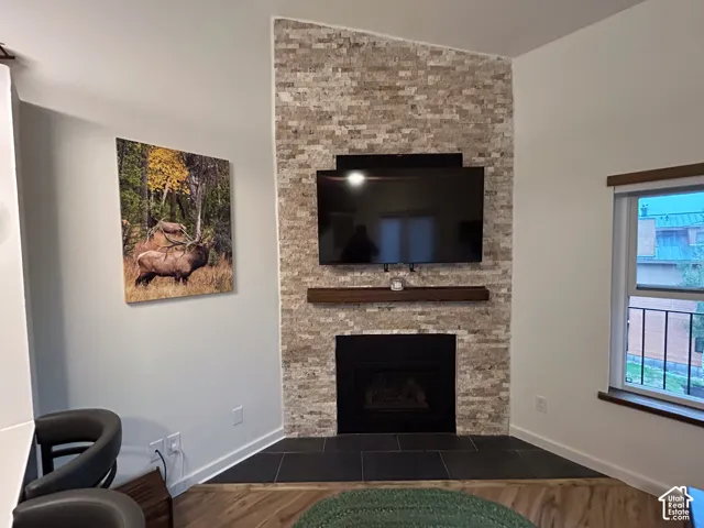 Built-in fireplace featuring a black firebox and a stone surround, complemented by a wood-finish mantel