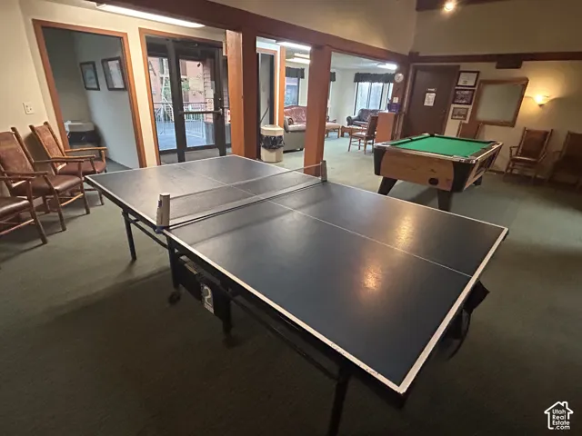 Recreation area featuring a table tennis setup, billiard table, and wood-framed entryways