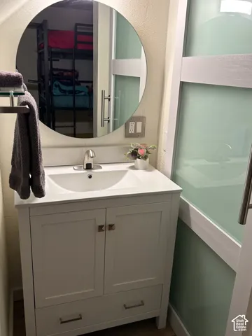 White vanity with an integrated sink and brushed nickel faucet