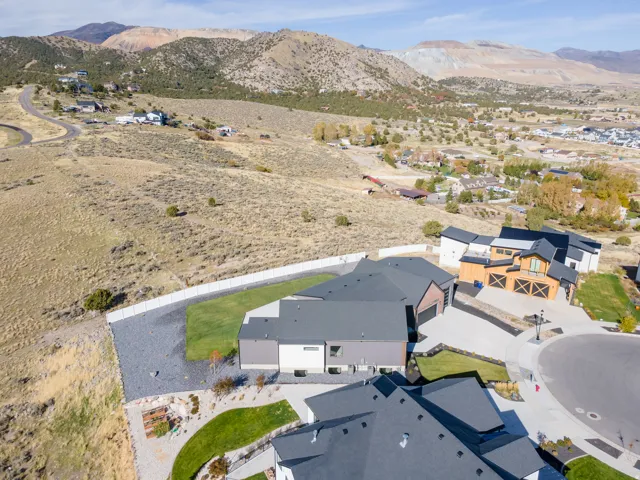 Expansive property featuring a flat yard area, concrete retaining walls, and a gravel-covered surface