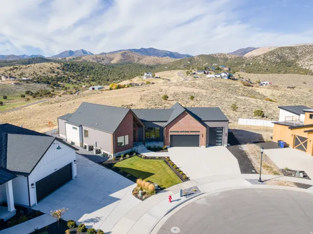 Modern exterior featuring brick and siding accents, a paved driveway, and an attached garage