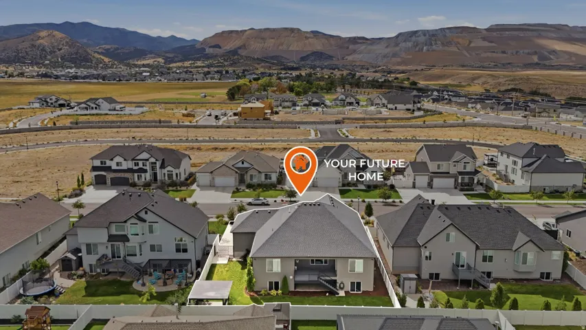 Two-story residence with a multi-gabled roof, featuring a private fenced backyard with a patio