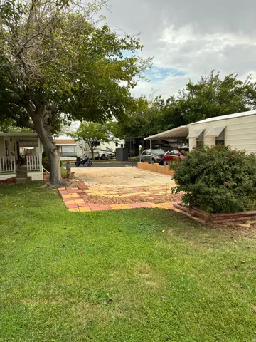 Expansive grass lawn with a paved patio