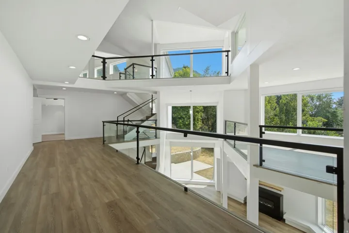 Expansive interior with multiple levels and wood-finish flooring